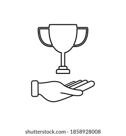 Hand holding Victory cup. First place cup. Minimalistic Trophy cup.