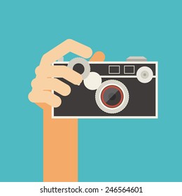hand holding vintage camera vector