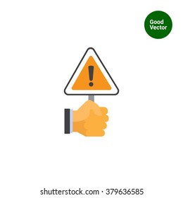 Hand holding warning sign