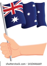 Hand holding and waving the national flag of Australia. Fans, independence day, patriotic concept. Vector illustration, eps 10.