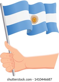 Hand holding and waving the national flag of Argentina. Fans, independence day, patriotic concept. Vector illustration, eps 10.