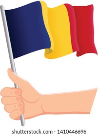 Hand holding and waving the national flag of Romania. Fans, independence day, patriotic concept. Vector illustration, eps 10.