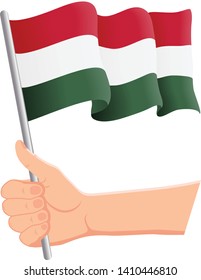 Hand holding and waving the national flag of Hungary. Fans, independence day, patriotic concept. Vector illustration, eps 10.