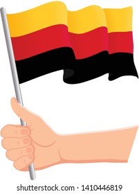 Hand holding and waving the national flag of Germany. Fans, independence day, patriotic concept. Vector illustration, eps 10.