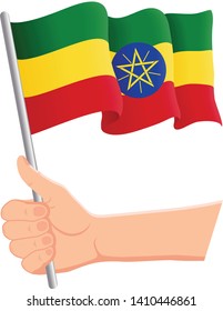 Hand holding and waving the national flag of Ethiopia. Fans, independence day, patriotic concept. Vector illustration, eps 10.