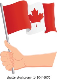 Hand holding and waving the national flag of Canada. Fans, independence day, patriotic concept. Vector illustration, eps 10.