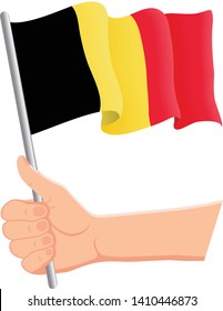 Hand holding and waving the national flag of Belgium. Fans, independence day, patriotic concept. Vector illustration, eps 10.