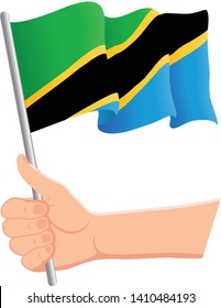 Hand holding and waving the national flag of Tanzania. Fans, independence day, patriotic concept. Vector illustration, eps 10.