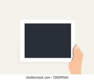Hand holding white digital tablet with empty screen