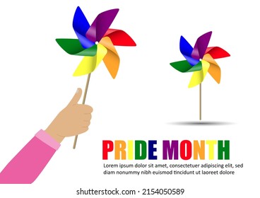 hand holding  windmill pride rainbow flag color on white background, pride month