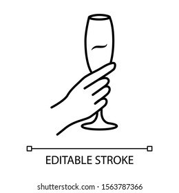 Hand holding wine glass linear icon. Champagne stemware. Glassful of alcohol drink. Wine service. Celebration. Thin line illustration. Contour symbol. Vector isolated outline drawing. Editable stroke