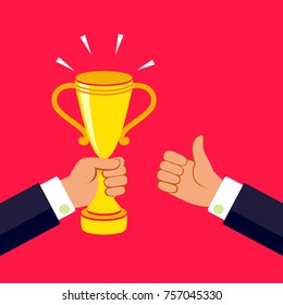 Hand holding a winner's trophy and thumb up. Vector illustration.