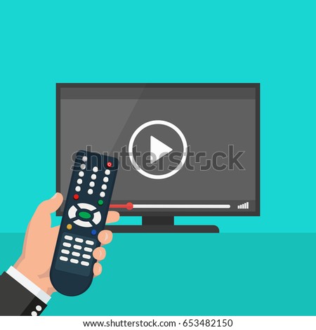 Hand holding wireless remote control near flat screen tv watching video film, cartoon person watching movie on television display
