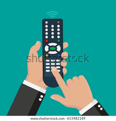 Hand holding wireless remote with finger pushing the button