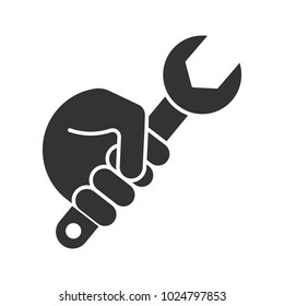 Hand holding wrench glyph icon. Silhouette symbol. Combination spanner. Negative space. Vector isolated illustration