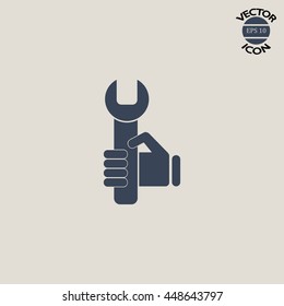 hand holding a wrench icon. Vector illustration