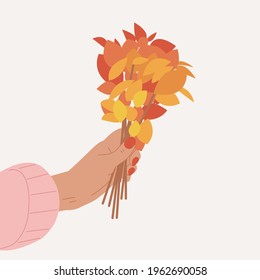 Hand Holds autumn leaves. Branches of trees in hand. Cartoon vector illustration. Harvesting Concept