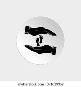 hand holds baby leg -  black vector icon