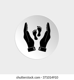 hand holds baby leg  - black vector icon