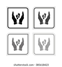 hand holds baby leg -  grayscale vector icon
