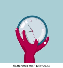 Hand holds the clock. Isolated on blue background.