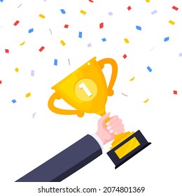 Hand holds first place winner golden award trophy goblet cup icon sign flat style design vector illustration isolated on white background.
