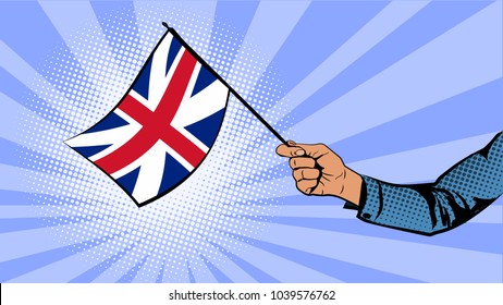 Hand holds the flag of Great Britain.