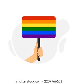 A hand holds a flag in support of the lgbt community. Vector illustration.