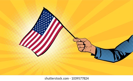 The hand holds the flag of the United States of America. Independence Day
