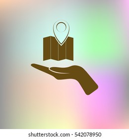 Hand holds folded paper map
