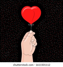 Hand holds heart balloon. Congratulation on St. Valentine