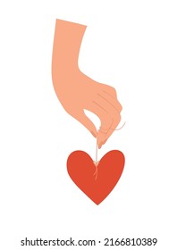 A hand holds a heart symbol on a string. Concept symbol of love, support, family, romance. Flat cartoon vector with red heart isolated on white.