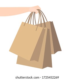 hand holds kraft paper bags. home delivery. Shopping, courier parcel to your home. ordering goods to your home via delivery service. flat illustration.