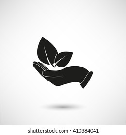 hand holds leaves - black vector  icon with shadow