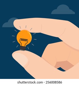 Hand holds light bulb