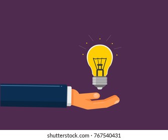 Hand holds the light bulb. Idea suggestion