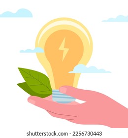 The hand holds a light bulb and leaves. Green energy. Caring for the resources of the planet.