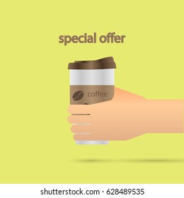 A hand holds a mug of coffee or a drink. Break for a cup of coffee.