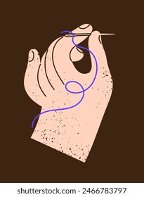 La mano sostiene la aguja y el hilo y cose