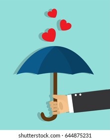 
The hand holds the open umbrella and the hearts do not get on top of the umbrella