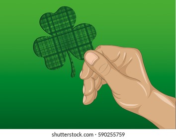 Hand holds ornate clover tree-leaf. Celebration concept St. Patrick's Day. Greeting card. Vector illustration on a green background. Free space for your text and labels