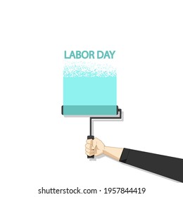 Hand holds a paint roller, Labor Day. 