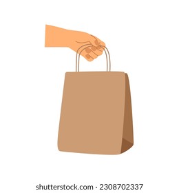 Hand holds a paper bag, for products. Concepts of ecological packaging, nature conservation, food delivery.