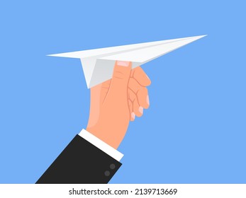 Hand holds paper plane. White airplane throwing. Blue sky background. Human arm. Origami aircraft flight. Startup concept. Launching new project. Traveling and messaging