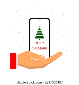 A hand holds a phone with the inscription Merry Christmas.