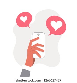 Hand holds the phone. New messages and likes on the phone. SMS valentines.