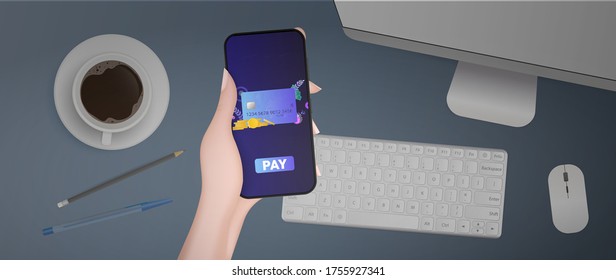 Hand holds phone with payment application. Payment button. Credit card, gold coins, dollars, computer, keyboard, cup of coffee, pen and pencil. The concept of online stores, payment and cashback. 