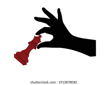 the hand holds a red chess piece, a queen, isolated on a white background