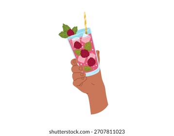 A hand holds a red raspberry drink