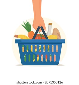 Hand holds shopping basket full of fresh produce. Buy grocery in the supermarket. Goods products into blue container. Modern flat vector illustration